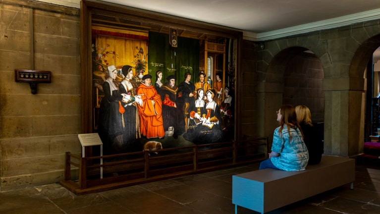 Visitors looking at Sir Thomas More and his Family painting by Hans Holbein the Younger at Nostell, West Yorkshire
